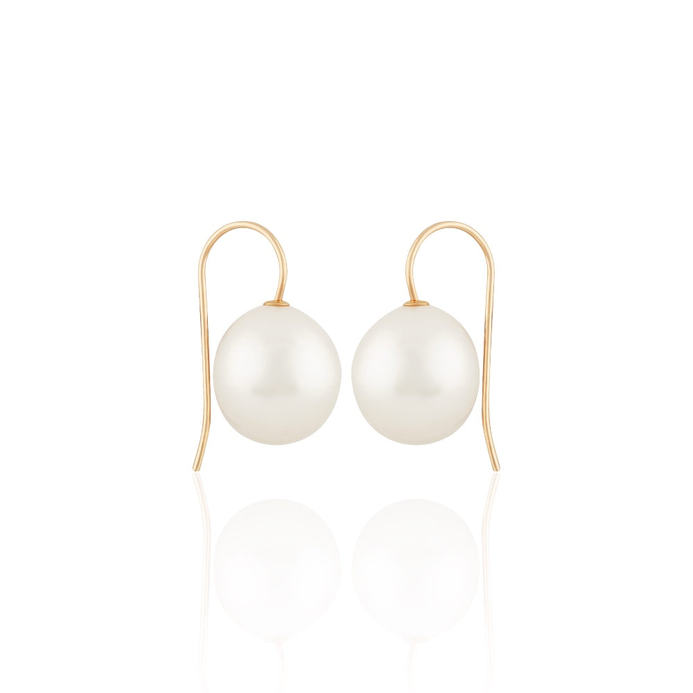 Pearl earrings with gold hooks on a white background
