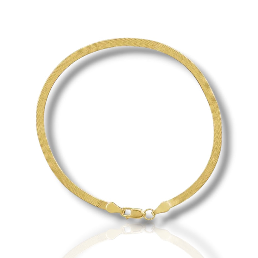 Gold herringbone bracelet on a white background
