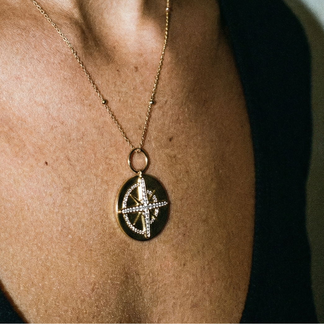 Necklace with a pendant worn by a person against a neutral background