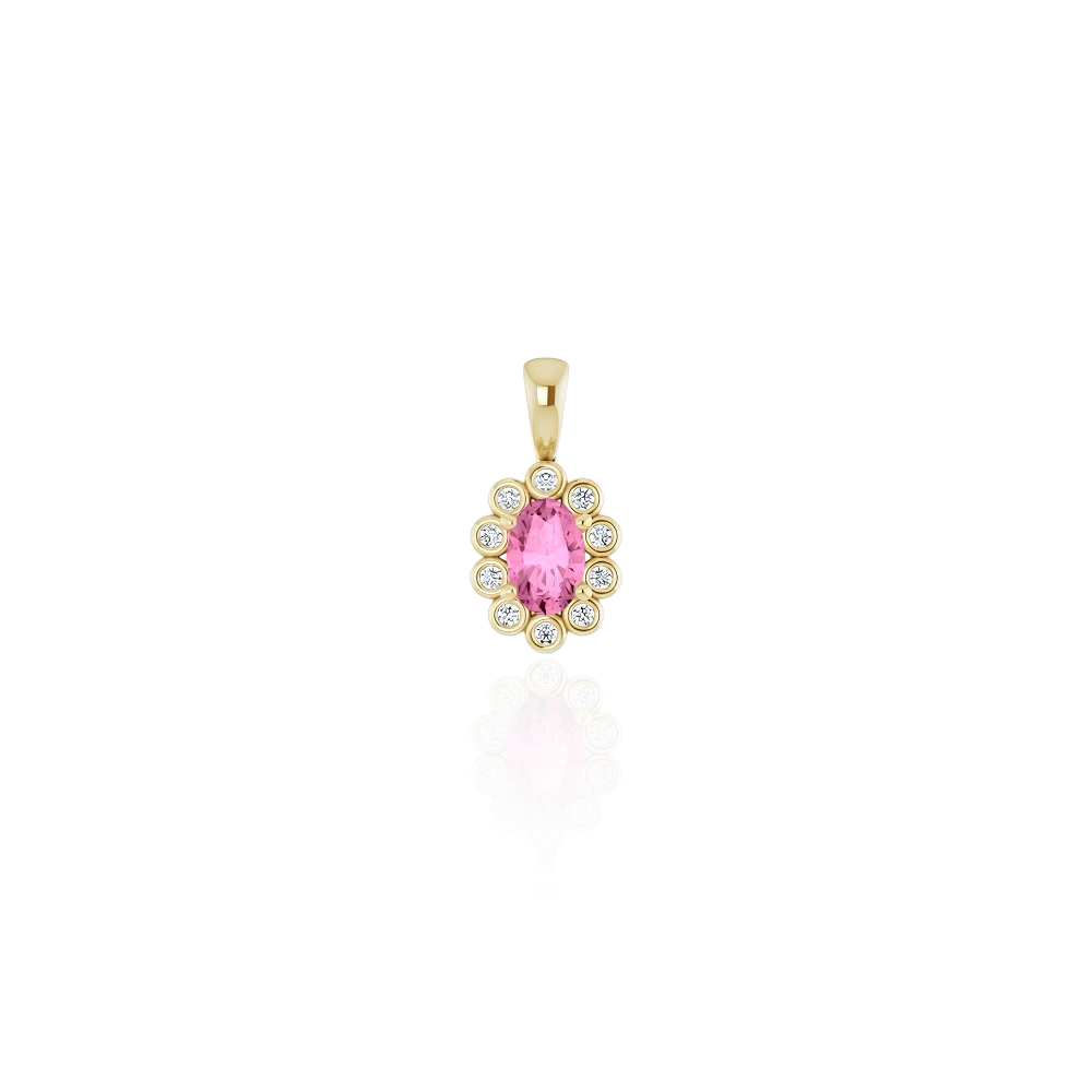 A gold pendant featuring an oval pink sapphire gemstone surrounded by a halo of small diamonds, set against a plain white background with a soft reflection below.