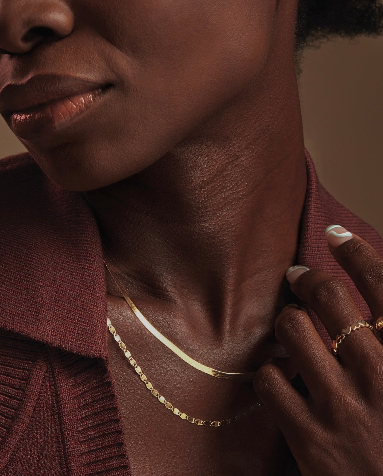 Mirror link necklace layered on a model's neck