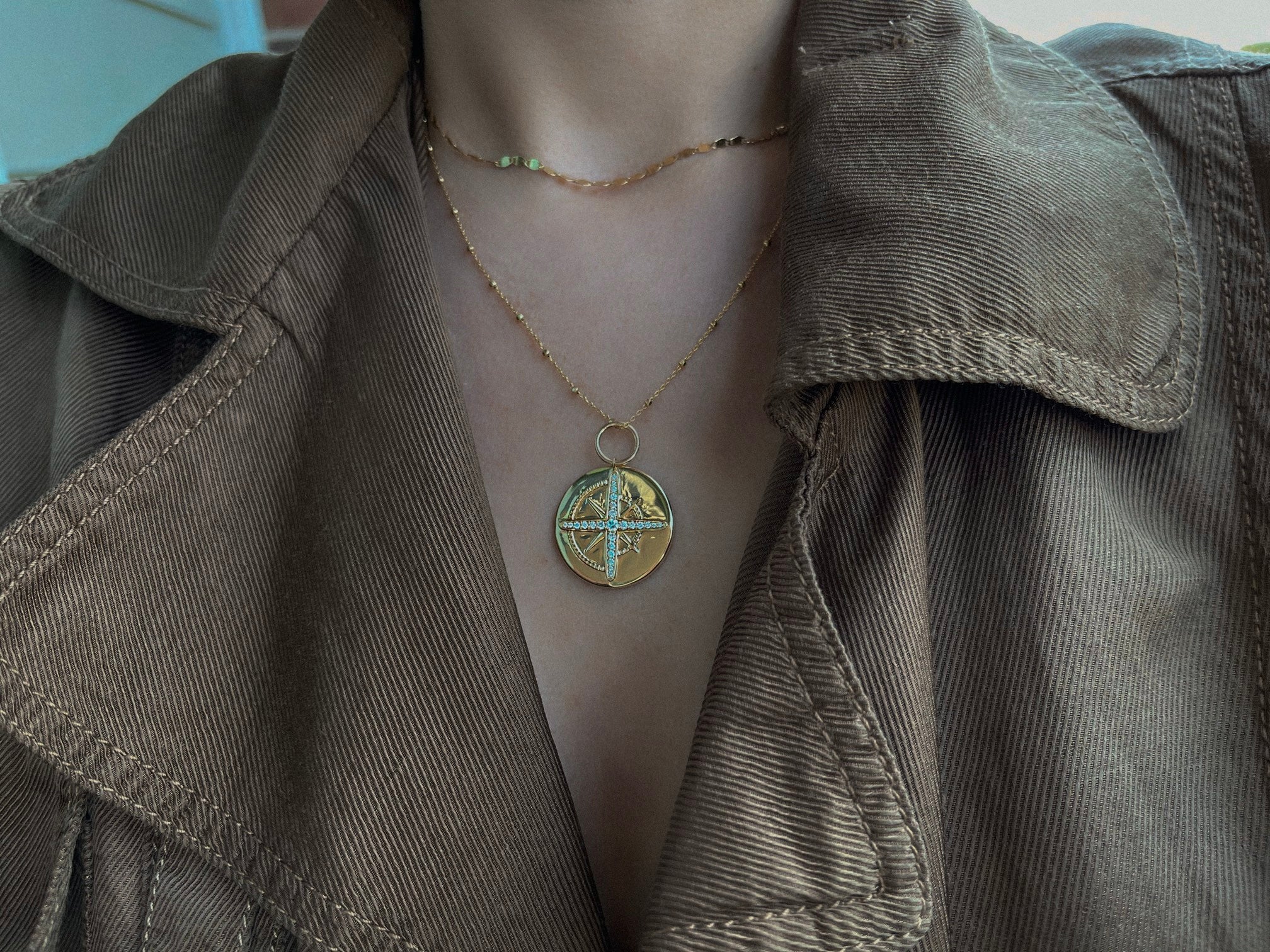 A woman wearing North Star Gold Diamond Necklace layered with another chain