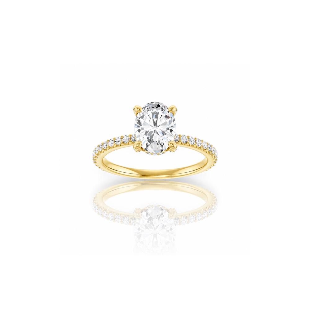 Gold ring with a large diamond and smaller diamonds on the band against a white background