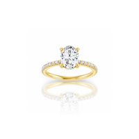 Gold ring with a large diamond and smaller diamonds on the band against a white background
