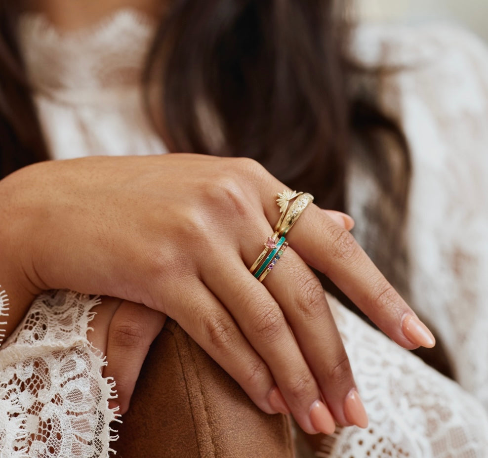 Model wearing unique gold stacking rings