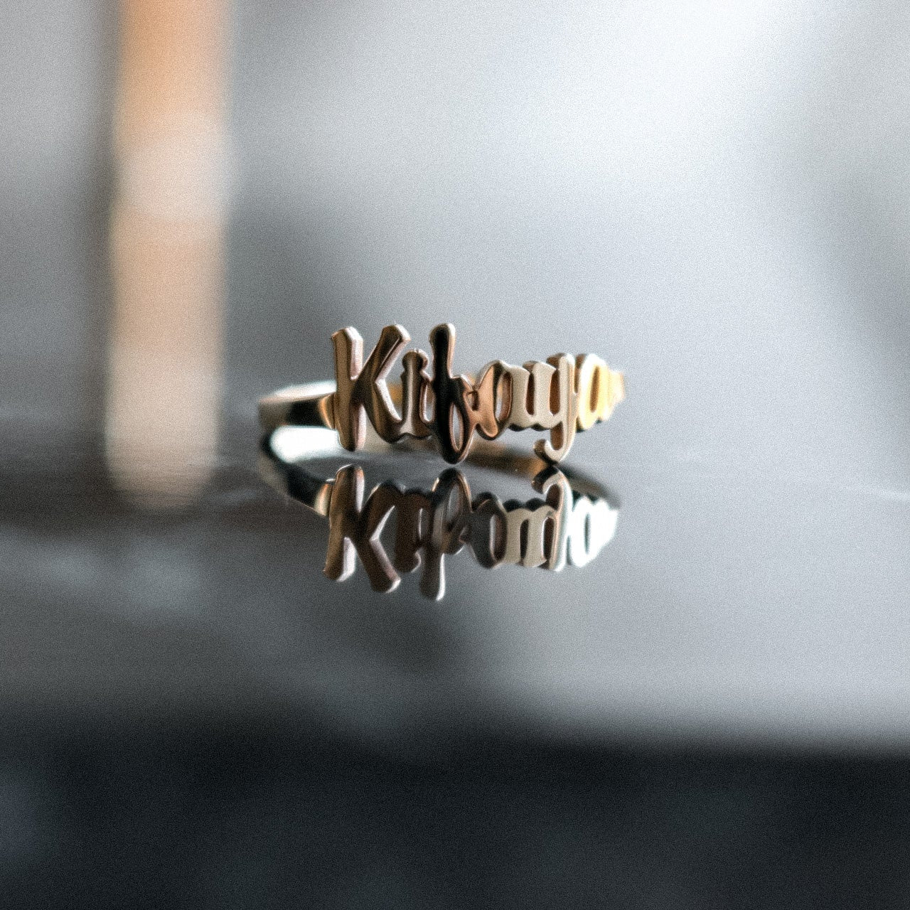 Gold Custom Name Ring on a dark background