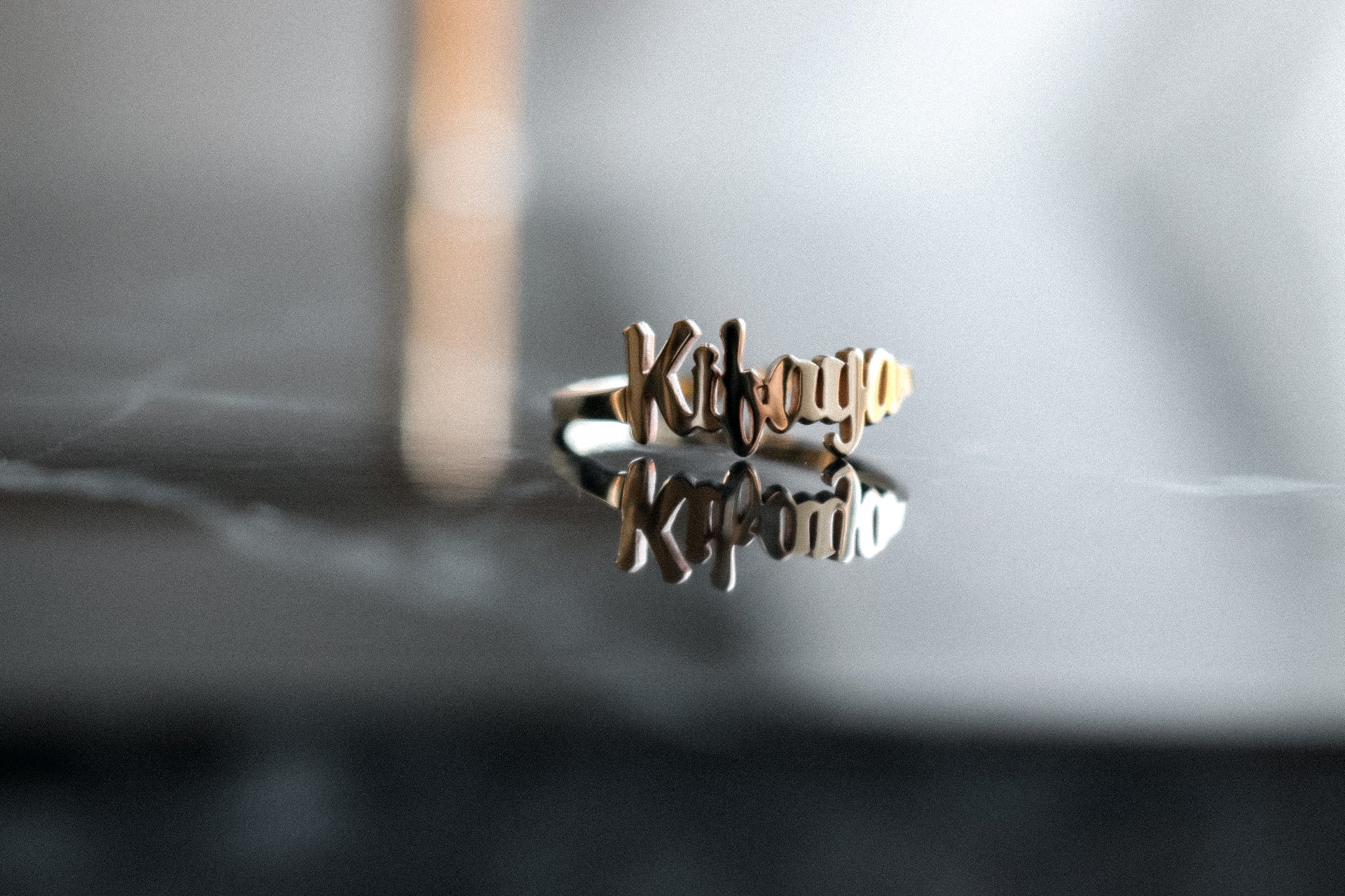 Gold Custom Name Ring on a dark background